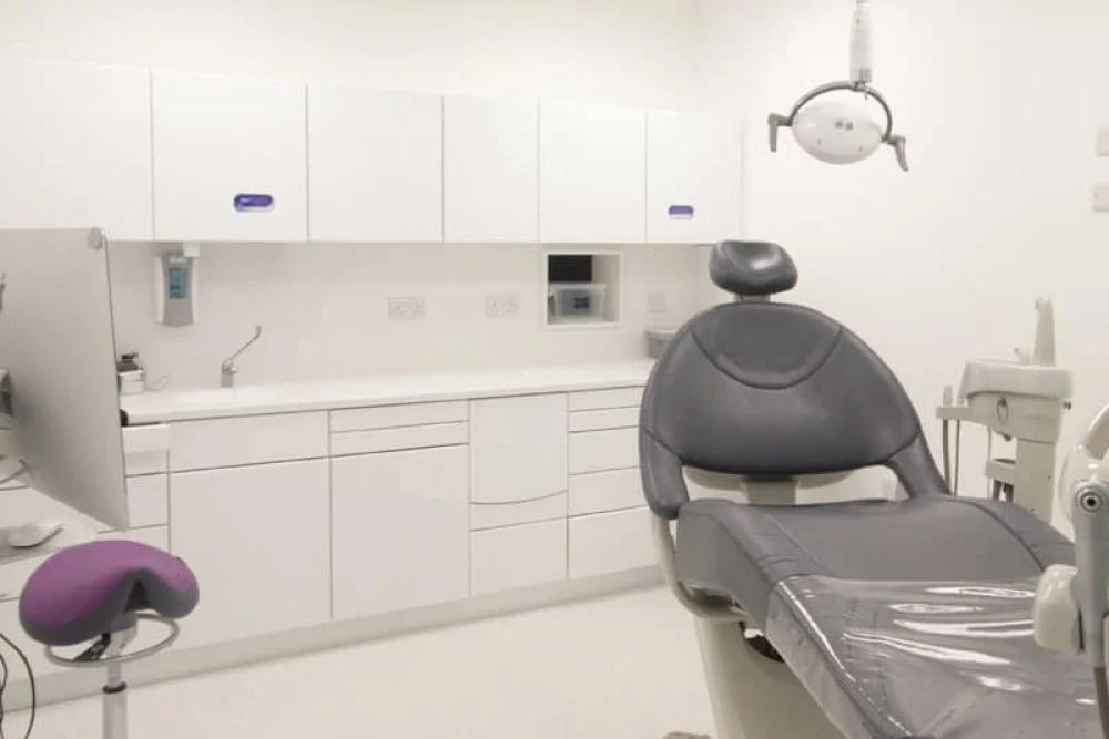 A treatment room at Smileworks with a dental chair and clinical equipment.