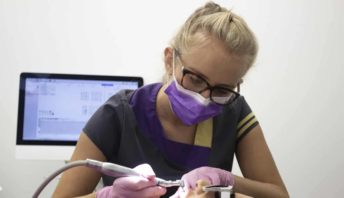 Smileworks dental therapist working with a patient.