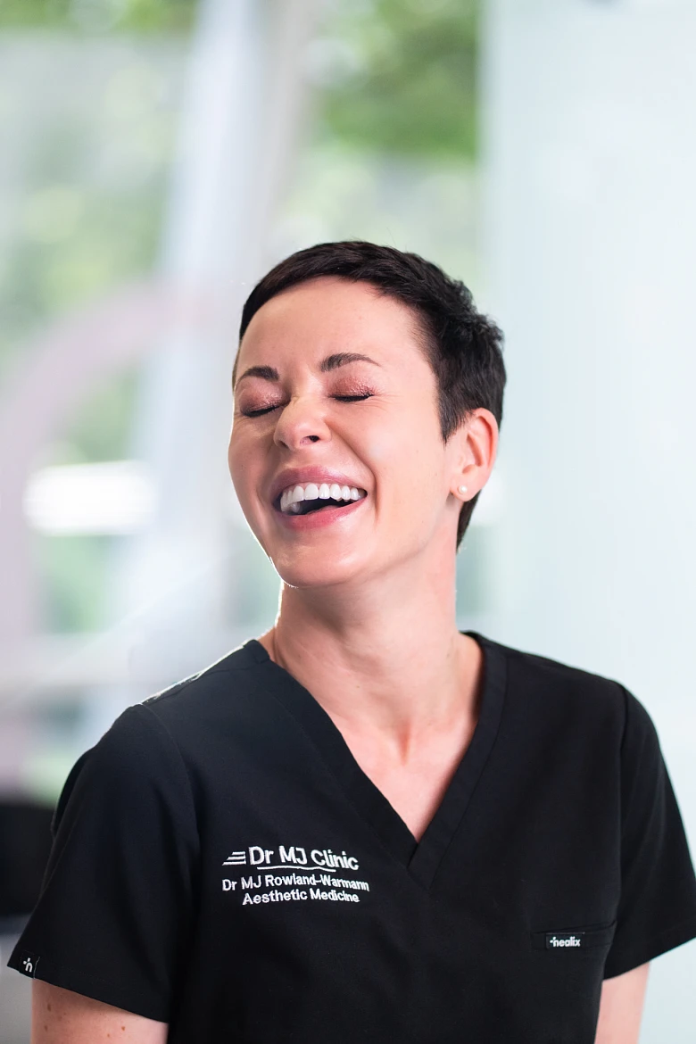 Dr MJ Rowland-Warmann smiling at Dr MJ Clinic