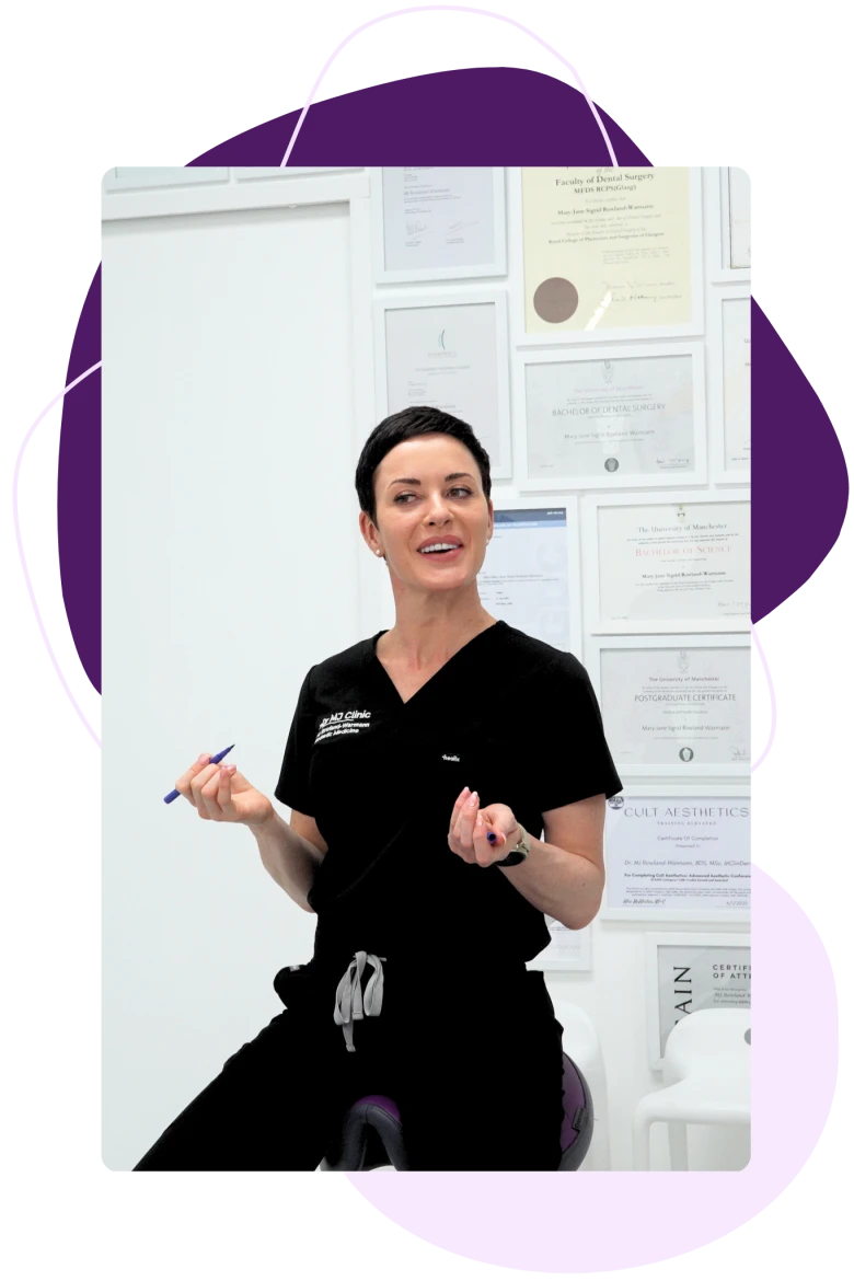 Dr MJ Rowland-Warmann at her clinic, beside her qualifications